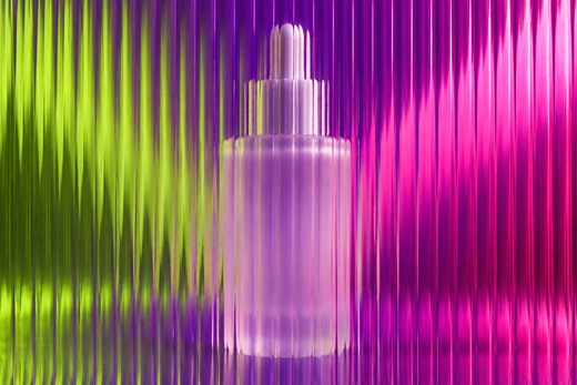 Unbranded frosted serum bottle behind textured glass in vivid coloured light.