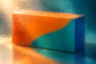 Unbranded closed rectangular multipack carton behind textured glass in vivid coloured light.