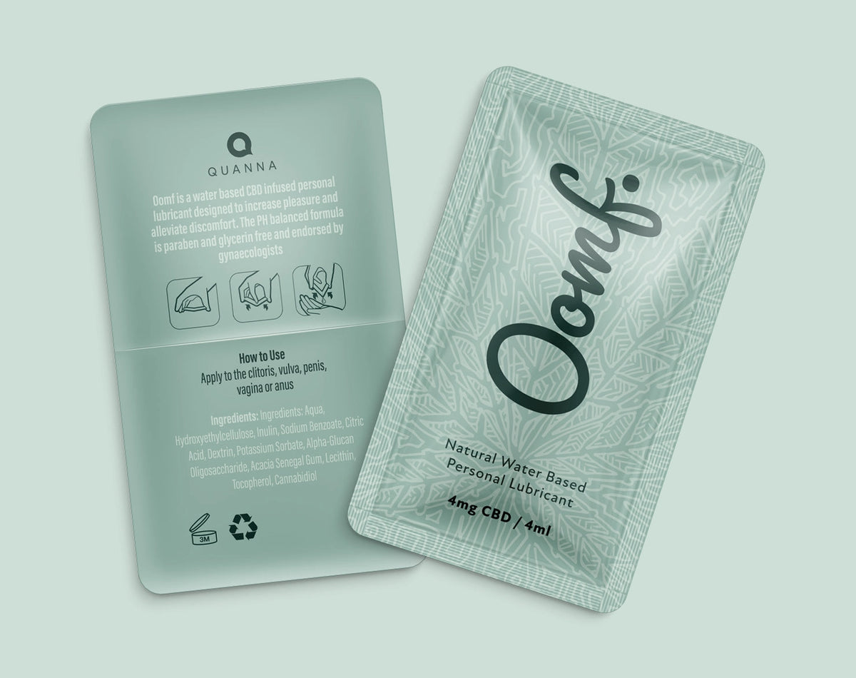 Two OOMF single-use sachets showing the script wordmark, patterned front artwork and instructional back panel.