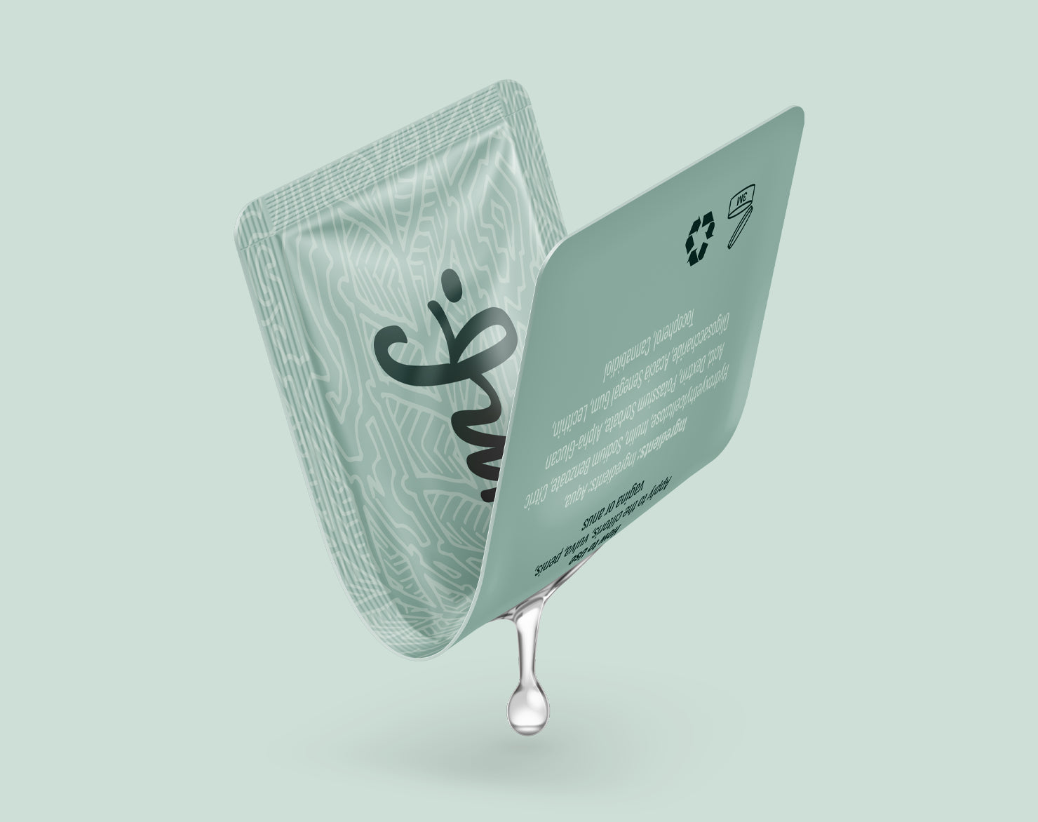 Opened OOMF personal lubricant sachet with a liquid drop, demonstrating the single-use flexible packaging format.