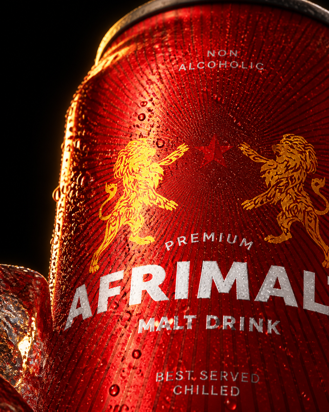 Extreme close-up of the AFRIMALT red aluminium can showing condensation, gold lions, central star and radial print detail