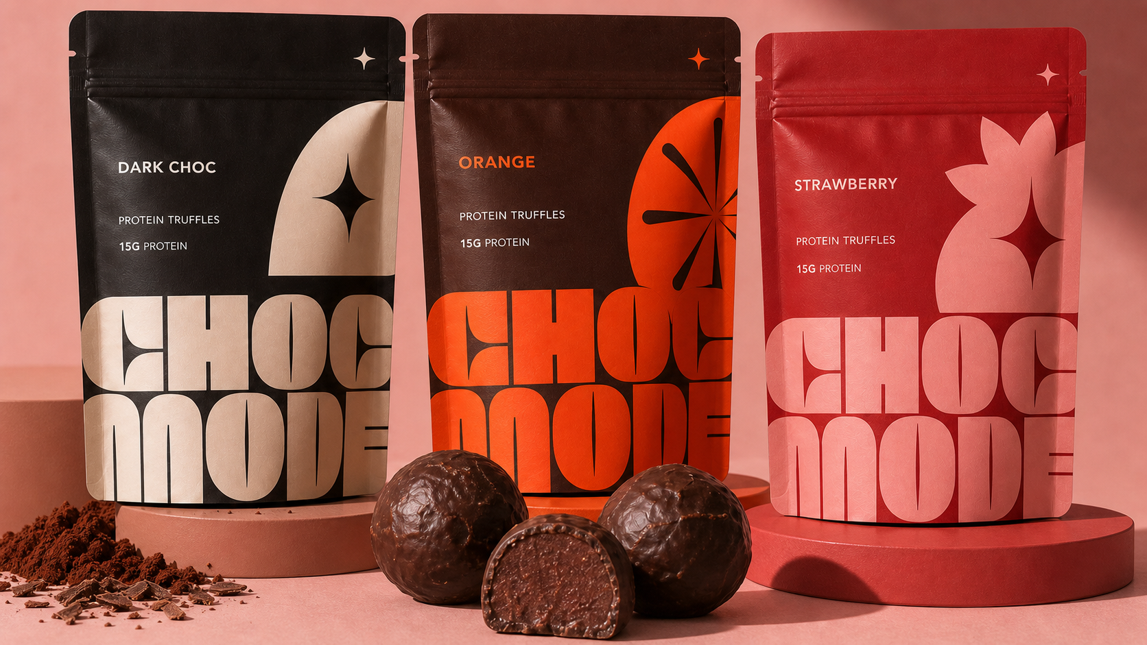 Three-flavour CHOC MODE pouch packaging lineup with dark chocolate, orange and strawberry protein truffles in the foreground.