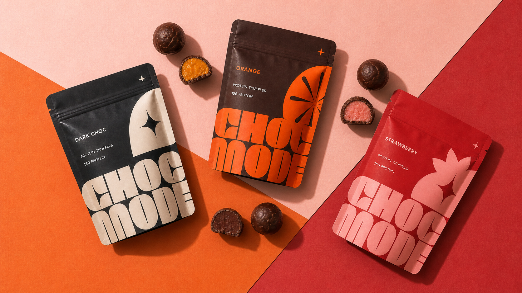 Overhead flat lay of three CHOC MODE protein truffle pouches and matching flavour centres on a colour-blocked editorial set.