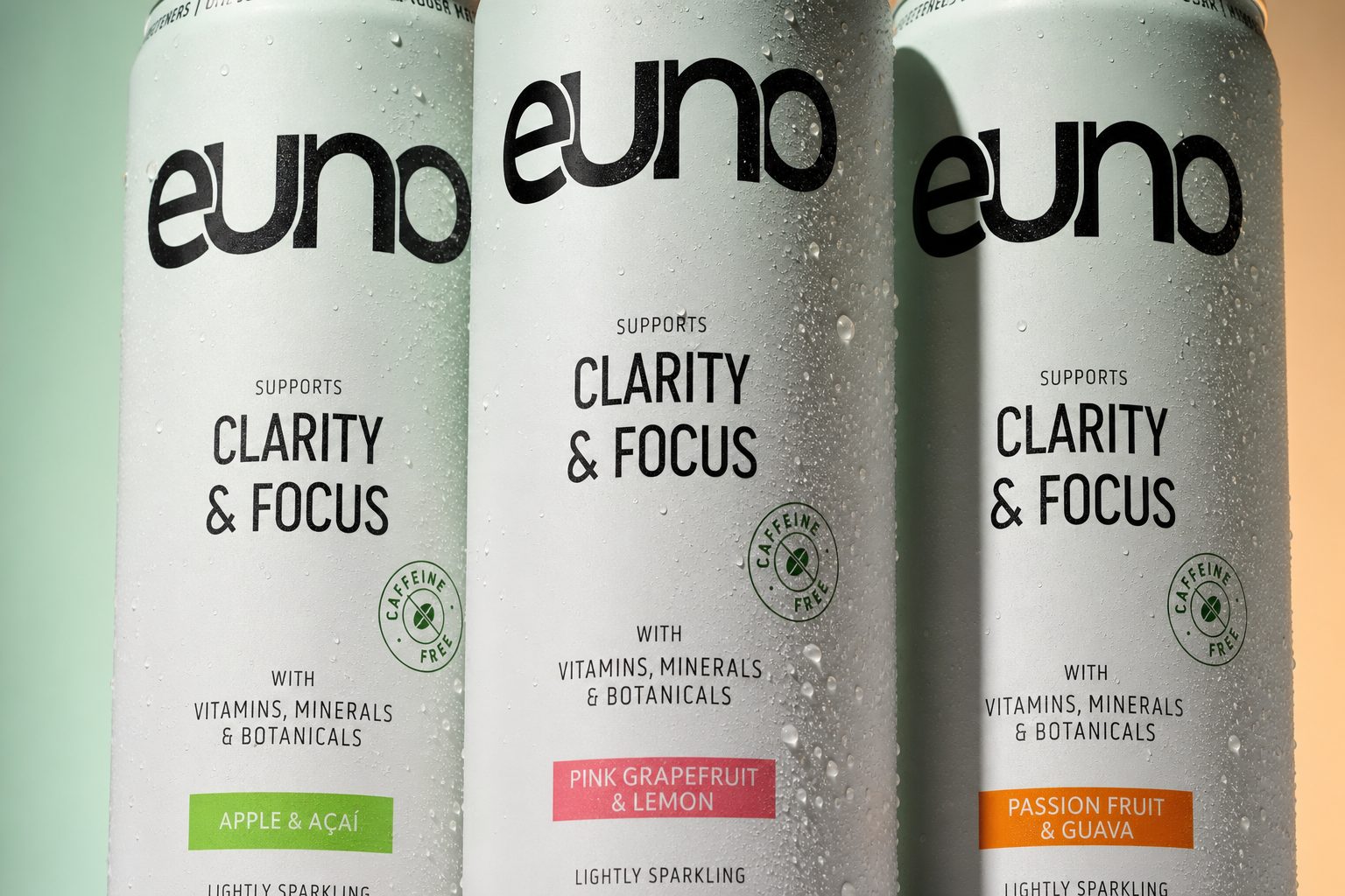Macro product photograph of the Euno functional drink range showing condensation, aluminium detail and green, coral and orange flavour coding
