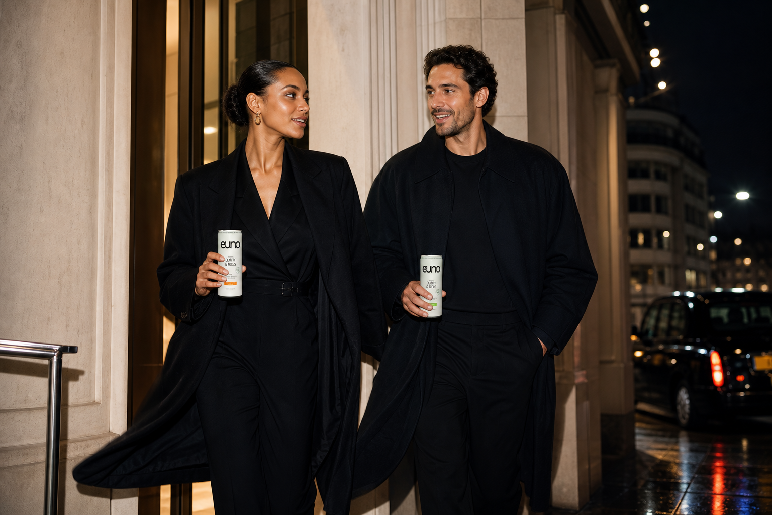 Two stylish professionals with Euno functional drink cans moving from a late Central London meeting into an evening gallery event