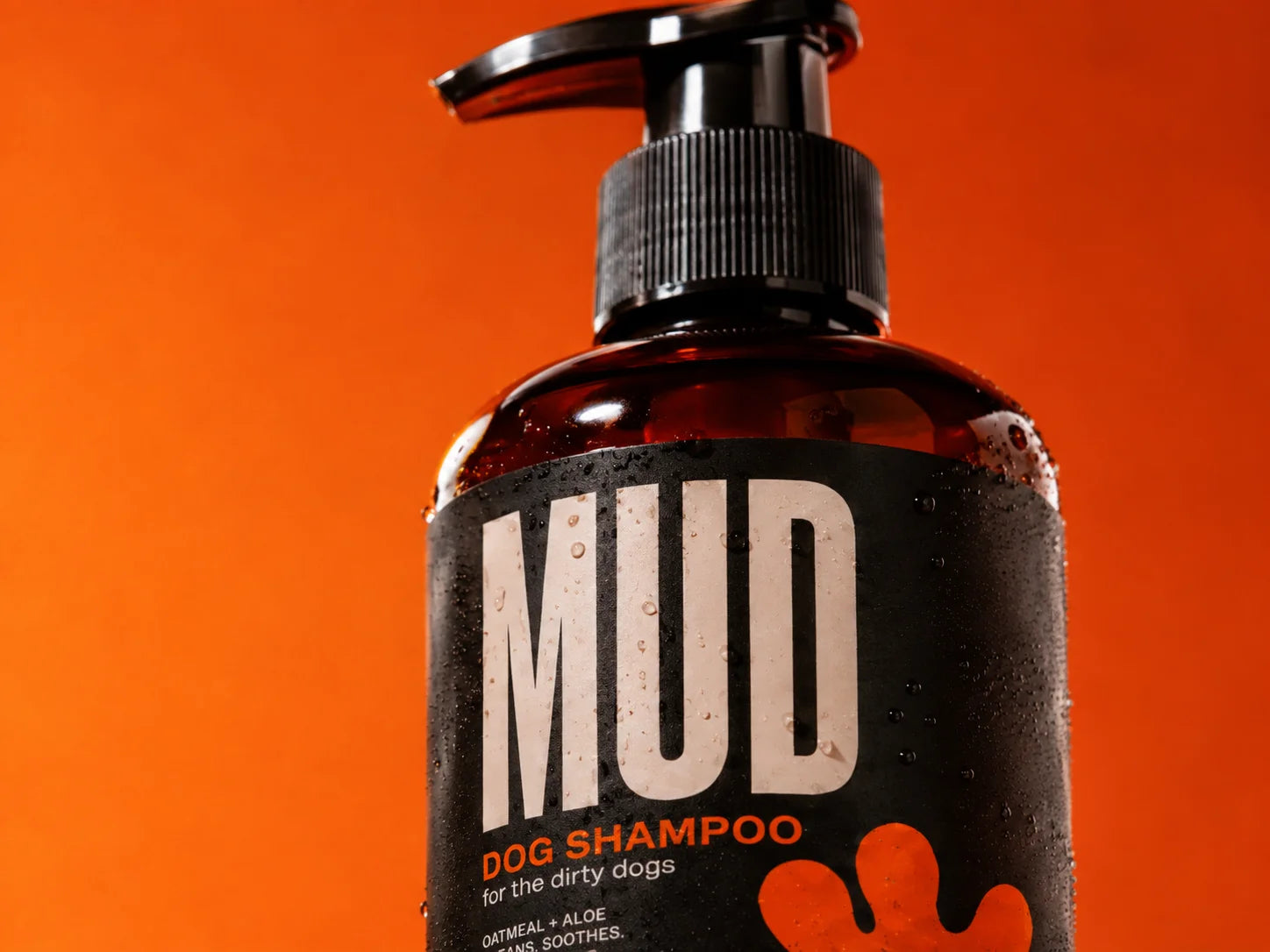 Close-up of the wet MUD dog shampoo label and black pump