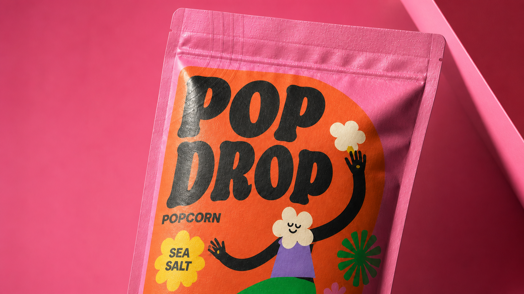 Close-up of the POP DROP popcorn pouch showing the bold logo, Sea Salt badge, matte material and illustrated front panel.