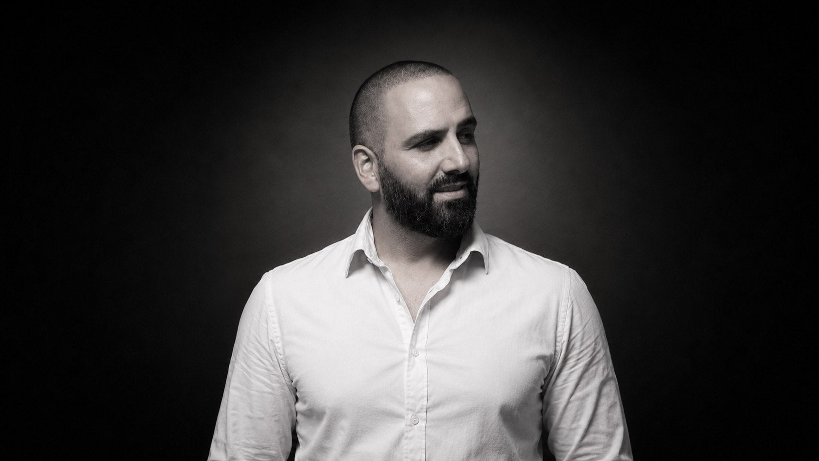 Tony Musso, freelance packaging designer, in a black-and-white studio portrait