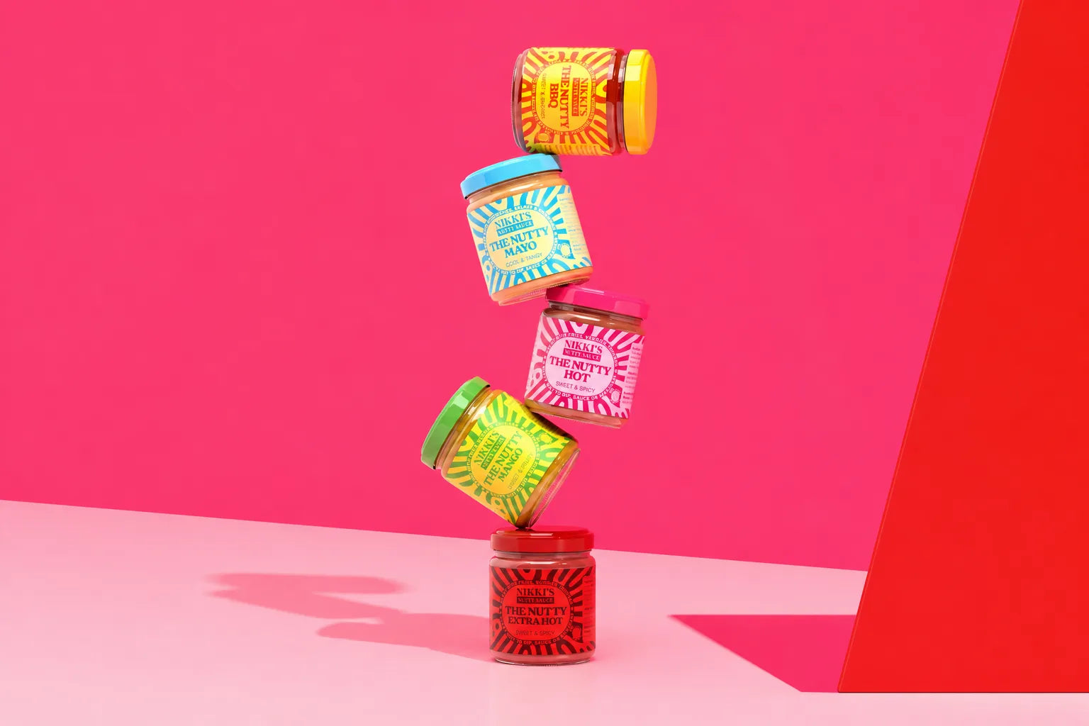 Front-facing Nikki's Nutty Sauces five-flavour bottle range